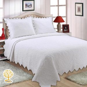 white intricately quilted bedspread cum quilt