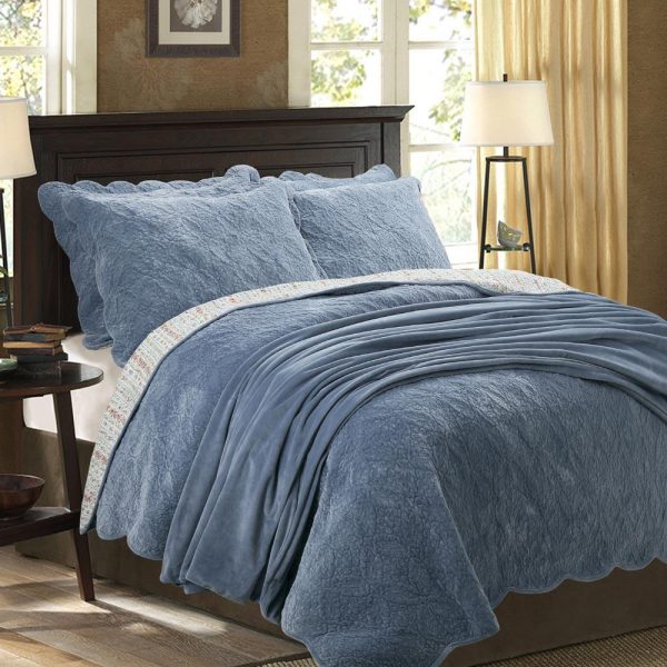 blue intricately quilted velvet bedspread