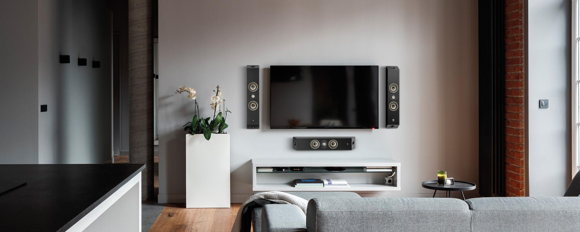 Focal On Wall 301 speakers arranged around a television in a manufacturer room visual